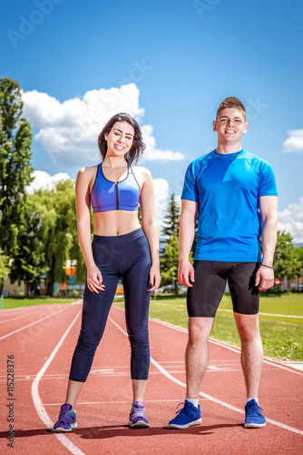 Two young athletes on track field.