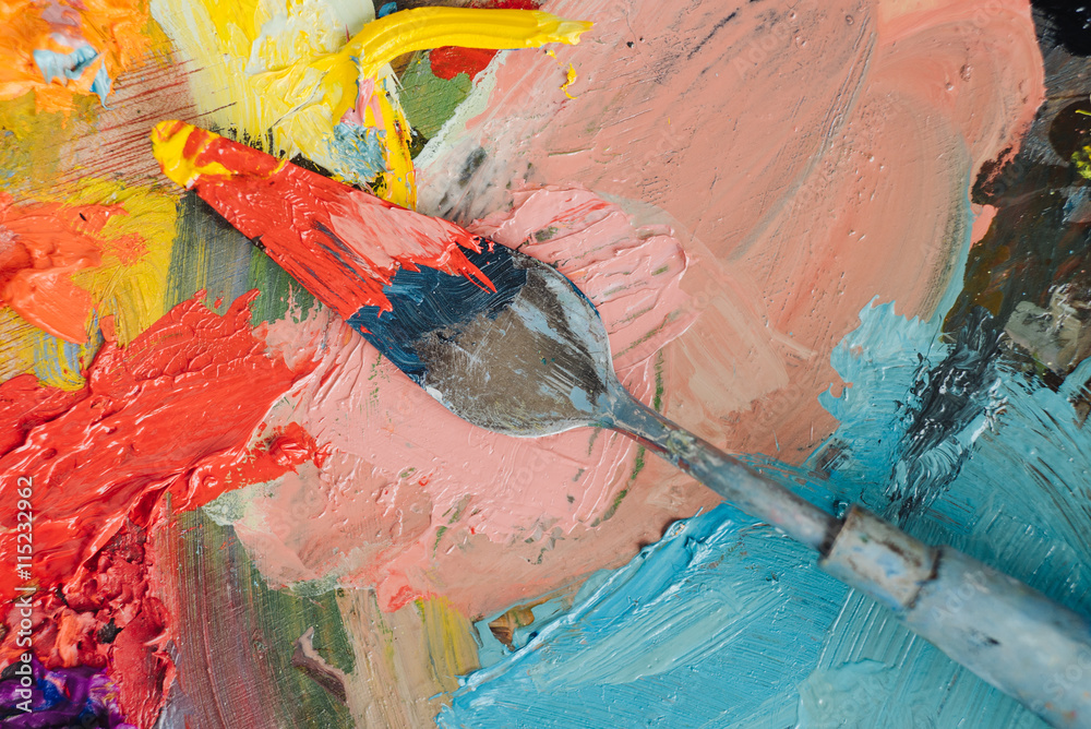 Obraz premium Professional acrylics orange paint on canvas and loaded palette knife