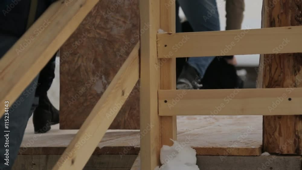 People climb on wooden construction to enjoy riding from icy hill. People climb on wooden construction to enjoy riding from icy hill.