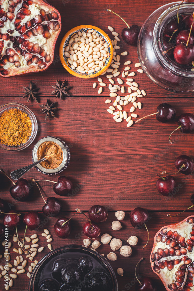 Different fruit and spices on the red wooden table. Concept of oriental fruits Different fruit and spices on the red wooden table. Concept of oriental fruits