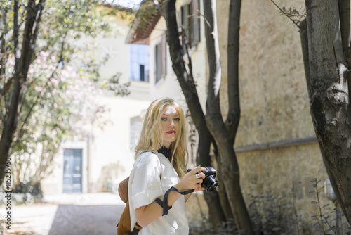 Portrait of blond woman with camera photo