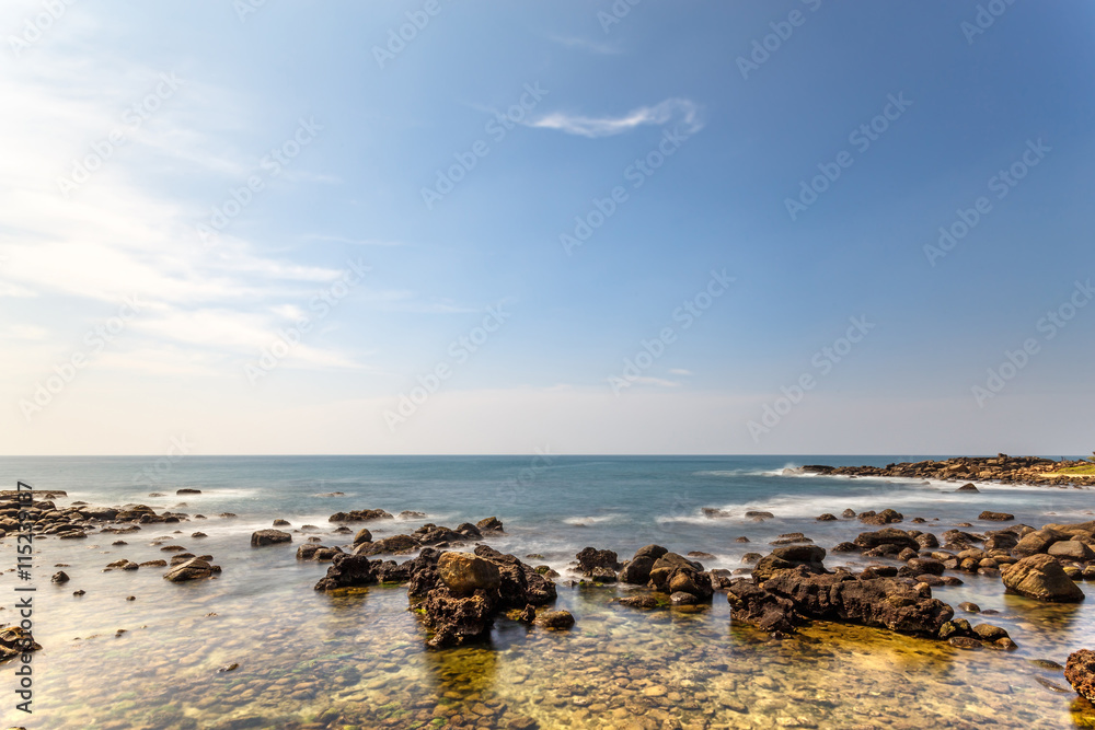 Palm tropical beach. Landscape rocky coast ocean.