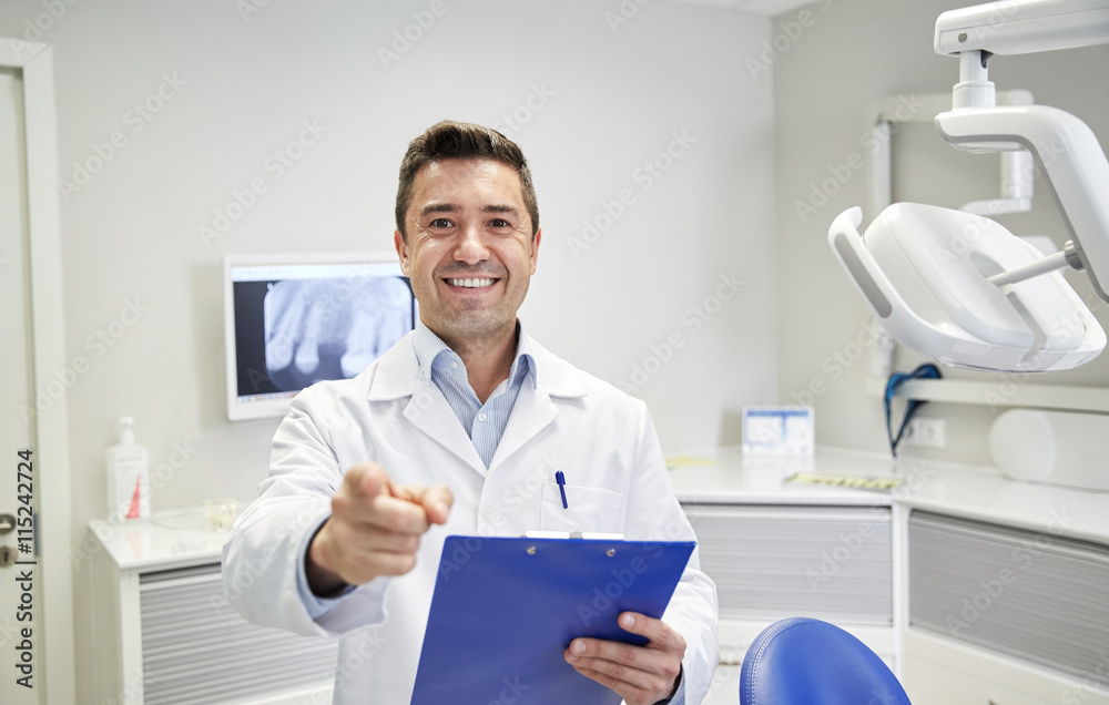 happy dentist pointing to you at dental clinic