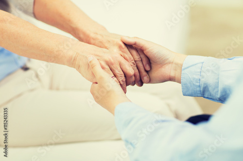 close up of senior and young woman hands