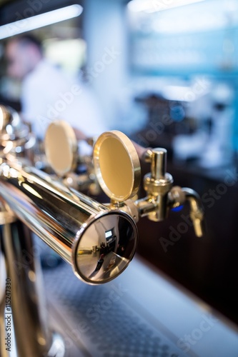 Close-up of beer pump in a row
