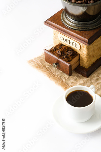 Coffee cup and coffee grinder isolated on a white background.

