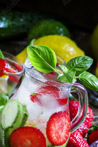 Lemonade with a strawberry, lemon, cucumber and basil, glass pit
