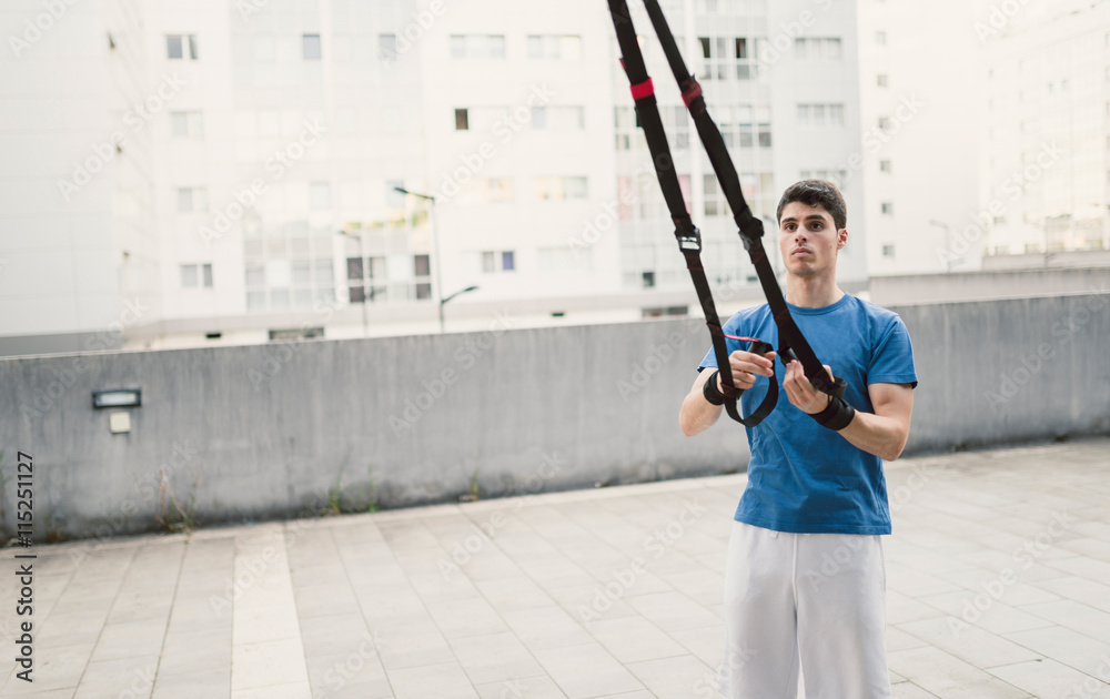 Sporty male ready to exercising with fitness trx straps