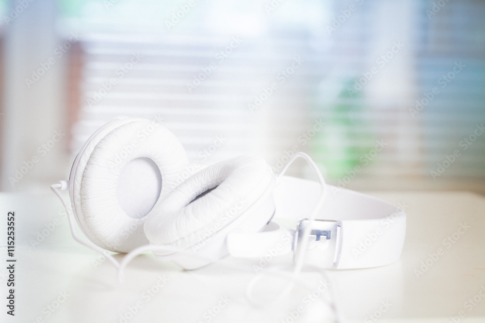 White headphones on a white table closeup. Music. Hobby. White headphones on a white table closeup. Music. Hobby.