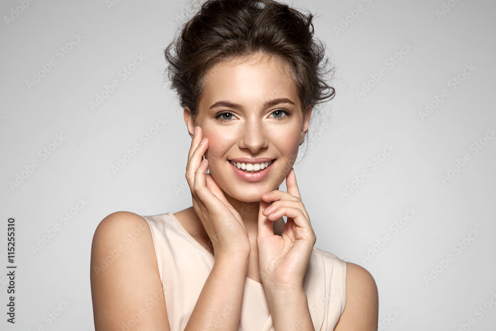 Fototapeta premium Portrait of a smiling young pretty woman with natural make-up