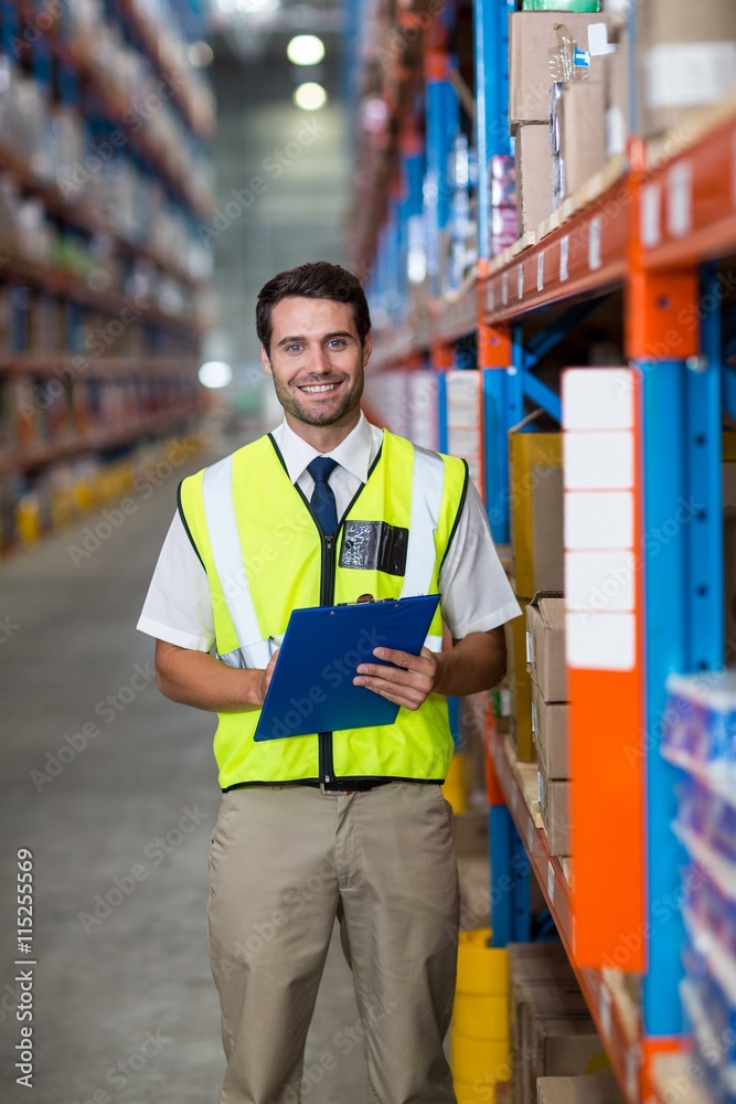 Worker with clipboard looking at camera Worker with clipboard looking at camera