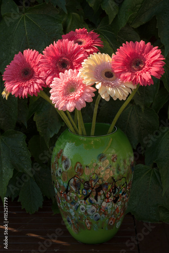 Gerbera daisies in green vase made from mosaic murano glass