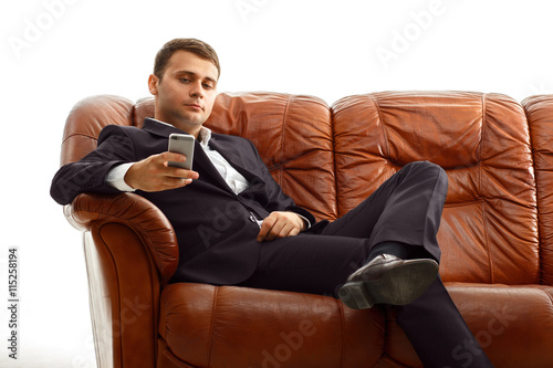 Businessman using phone .sitting on the couch