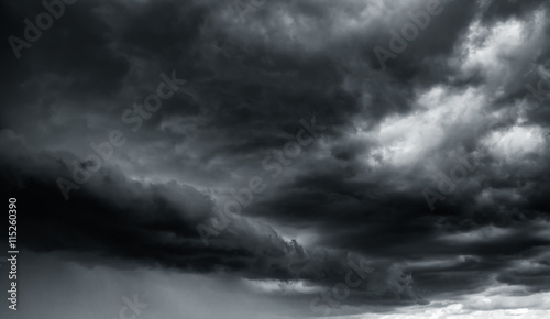 Dramatic thunder storm clouds at dark sky photo