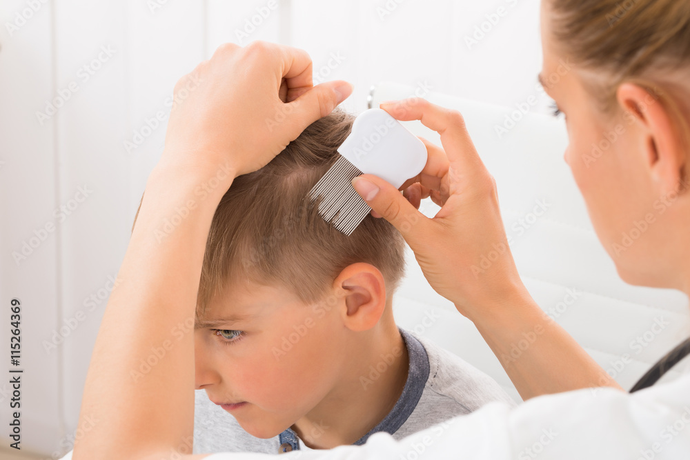 Naklejka premium Doctor Doing Treatment On Boy's Hair