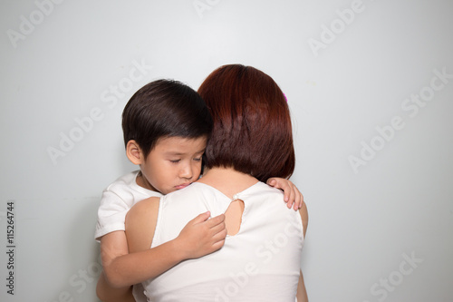 3 years old Asian kid hug his mother on white background