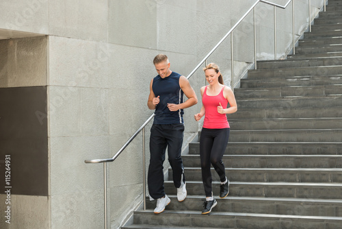 Couple Running Together On Stairs