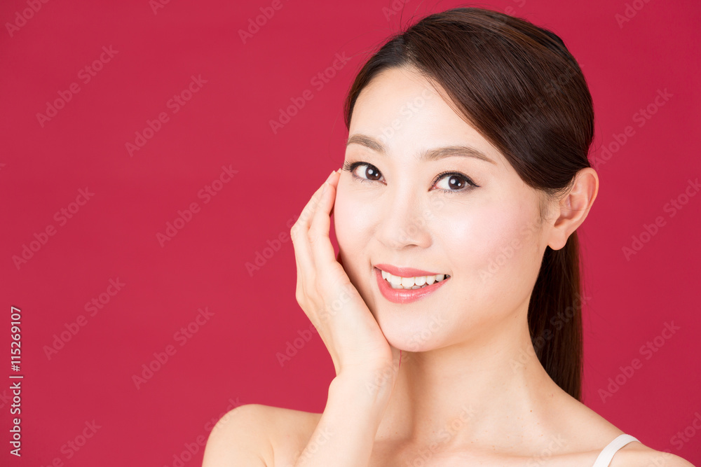 attractive asian woman isolated on red background attractive asian woman isolated on red background