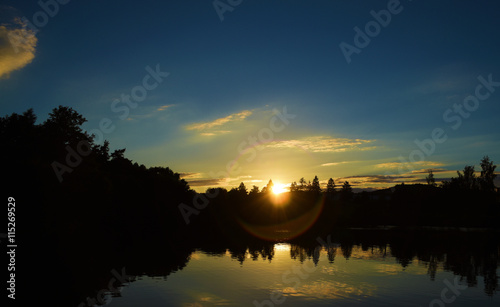 Sunset near small town Okrisky near pond photo