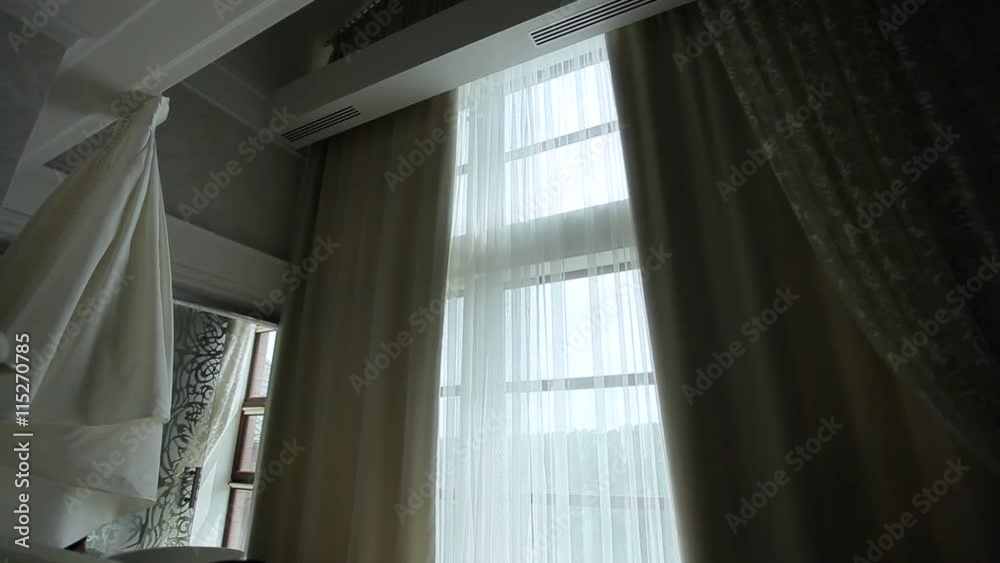 Auto-closing curtains in the apartment with a large window. Auto-closing curtains in the apartment with a large window.
