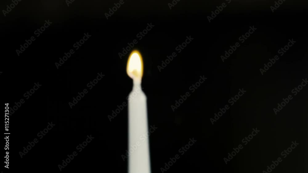 Man hand ignite white candle by red lighter Man hand ignite white candle by red lighter