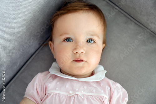 Baby laying on sofa, closeup