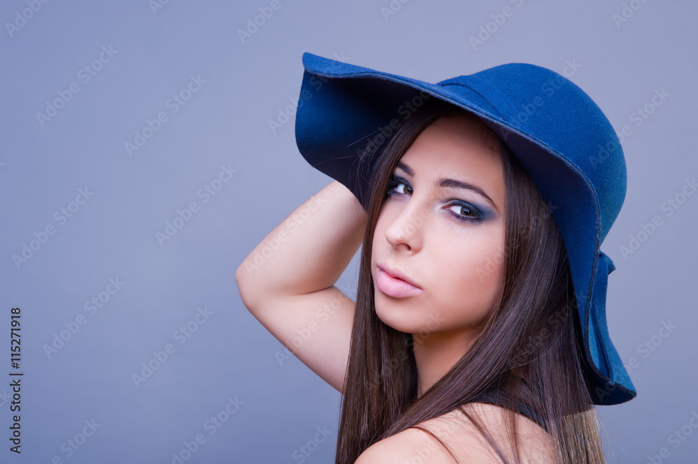 Beautiful girl with blue hat. Studio shot. Beautiful girl with blue hat. Studio shot.