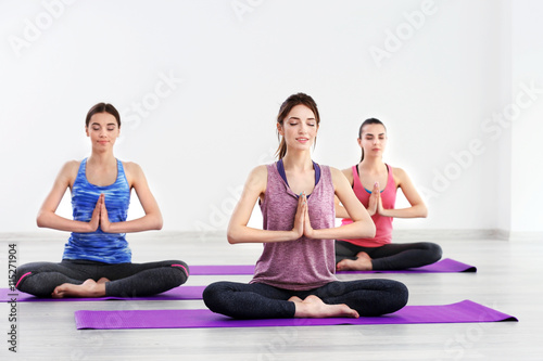 Young women doing yoga in gym
