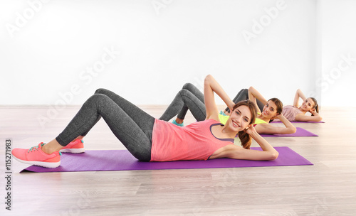 Young women doing exercise in gym