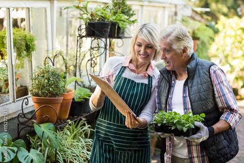 Wallpaper Mural Woman showing clipboard to male gardener Torontodigital.ca