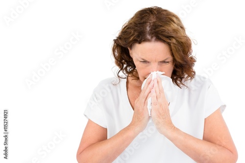 Irritated mature woman sneezing