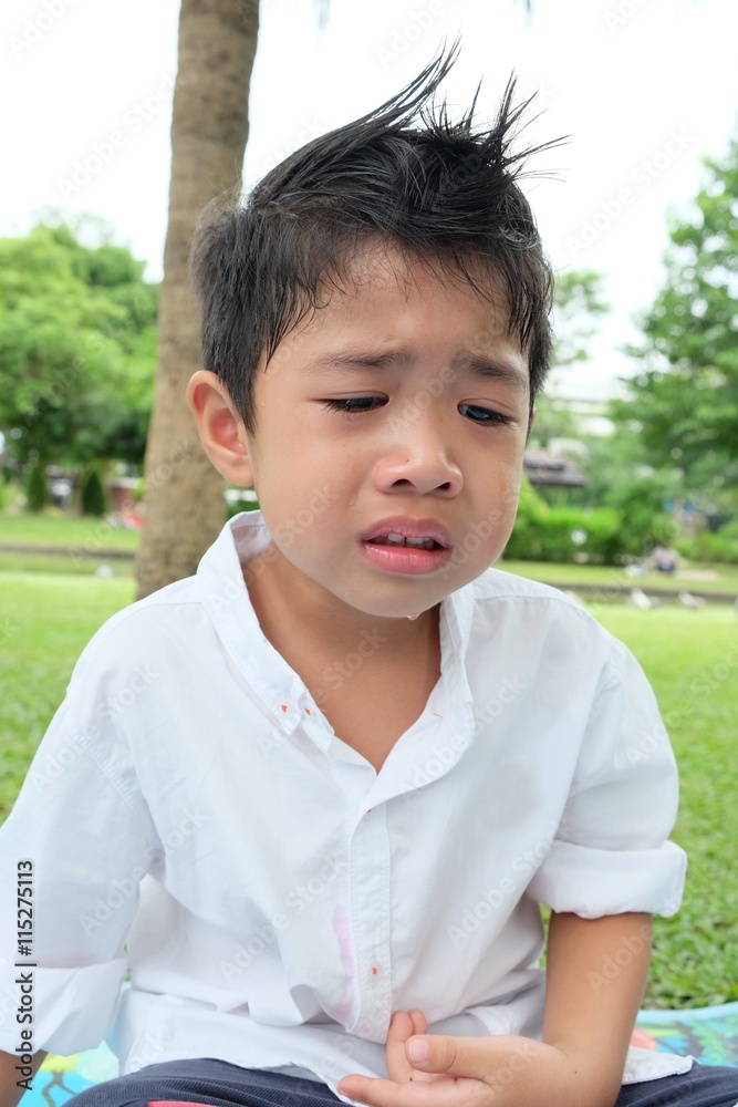 Boy crying in park Boy crying in park