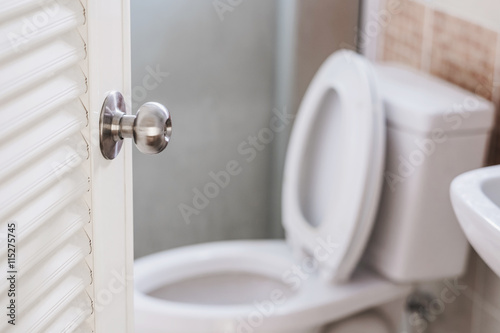 Close up, Toilet door opening, with stationery ware, selective focus on door knob photo
