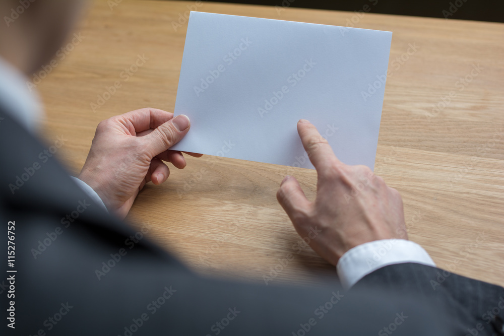 businessman holding white blank paper businessman holding white blank paper