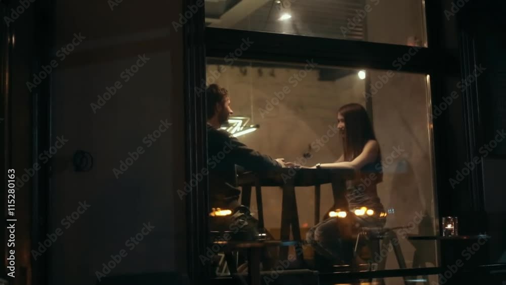 Happy Young Woman feeding her boyfriend in cafe - Ouside shot Happy Young Woman feeding her boyfriend in cafe - Ouside shot
