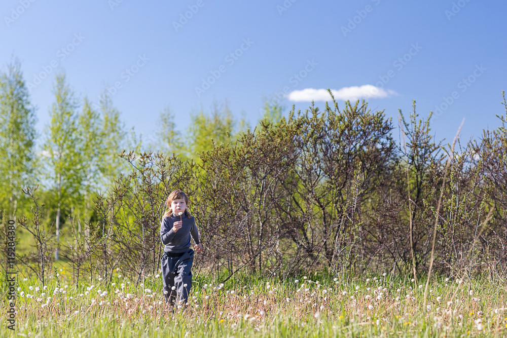 boy running in the park boy running in the park