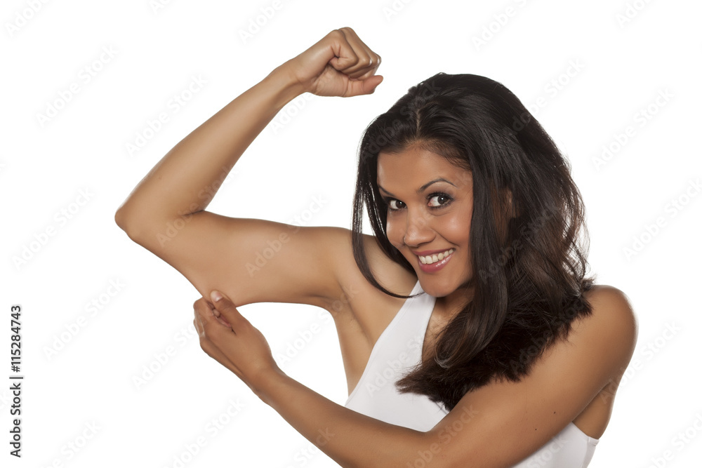 young beautiful woman pinching the skin on her arm young beautiful woman pinching the skin on her arm