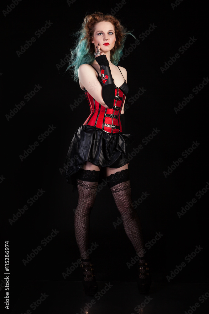 Alternative fetish model in red corsait on black background Alternative fetish model in red corsait on black background