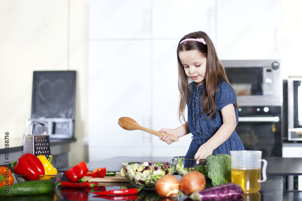 little daughter cooking in the kitchen
