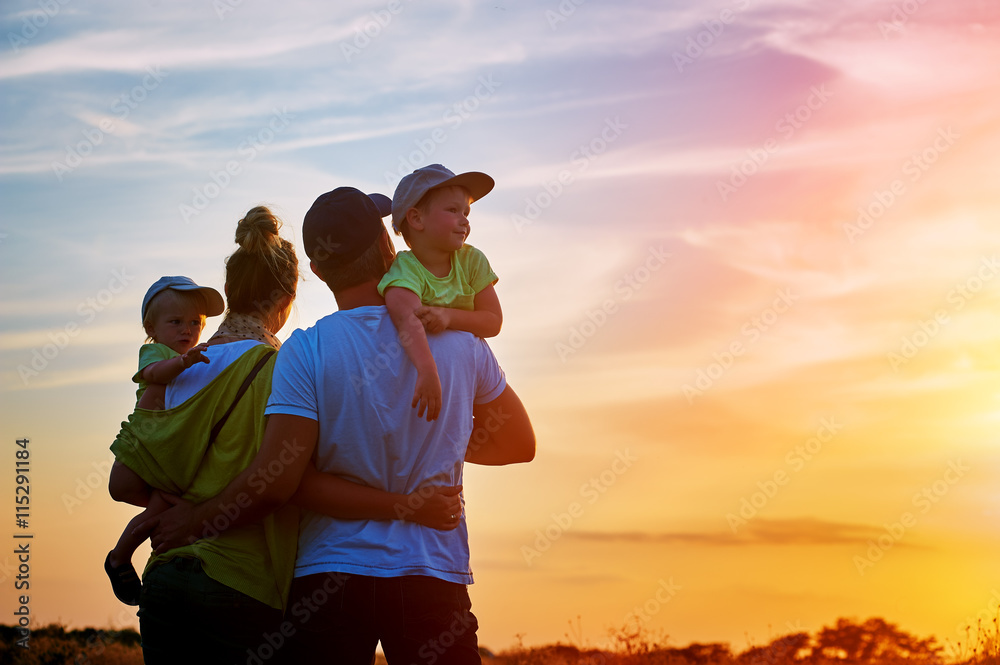 happy family at sunset. father, mother and two children
