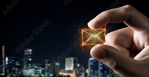 Email symbol between fingers . Mixed media