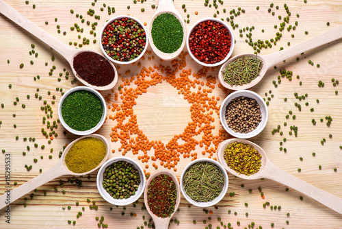 Spices  in spoons on wooden table