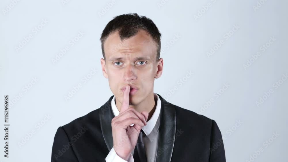 Businessman silent quiet gesture with finger Businessman silent quiet gesture with finger