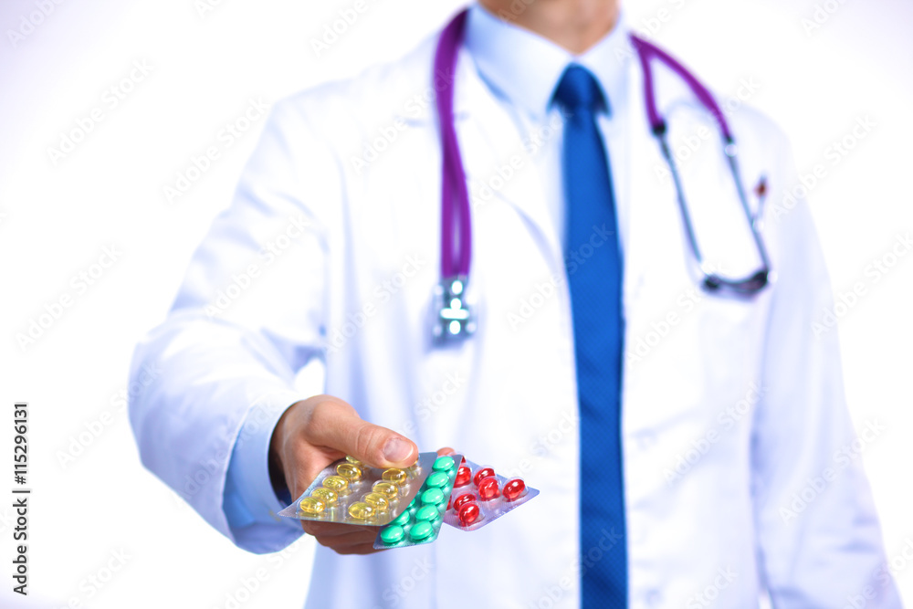 A young doctor holds the patient's hand with pills A young doctor holds the patient's hand with pills