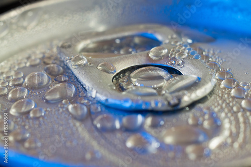 pop cans with drops of water closeup in blue light