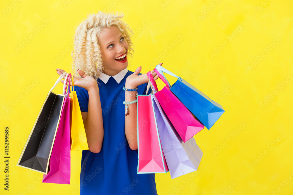 Excited woman with shopping bags looking up Excited woman with shopping bags looking up
