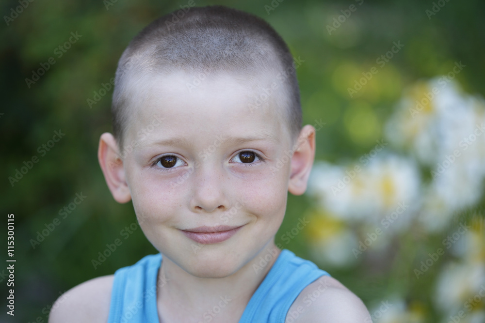Headshot of smile happy boy wearing blue shirt isolated on nature background. Headshot of smile happy boy wearing blue shirt isolated on nature background.