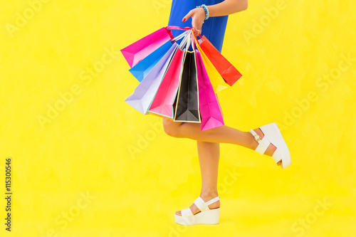 Woman with shopping bags in one hand