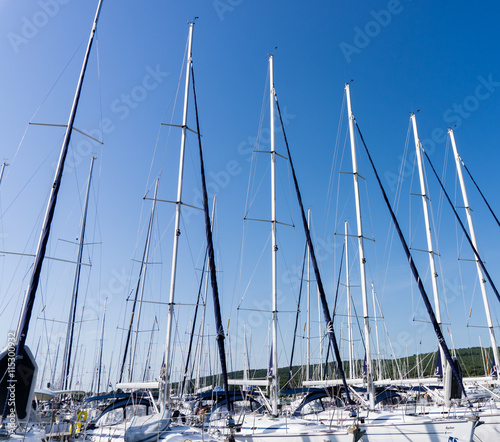 mast against a blue sky, ship mast, marina in European city, the