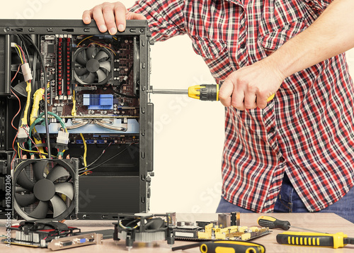 Technician repair assembles computer. 